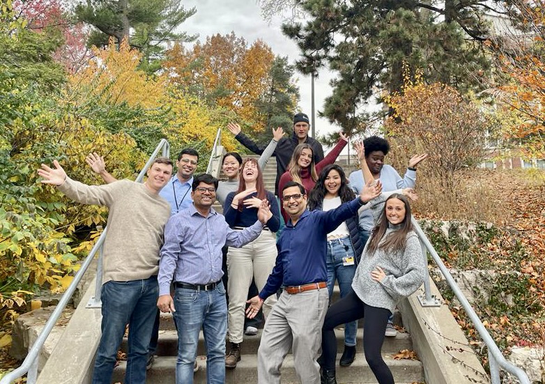 Dr. Mangalam's Lab Group making fun poses on a staircase