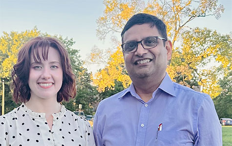 Stephanie and Ashutosh in front of some colorful leaves